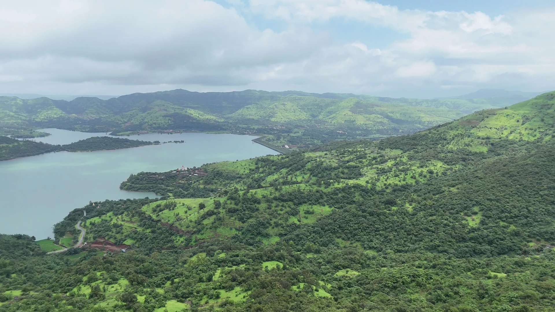 Backwaters and green mountain ridges surrounding the project